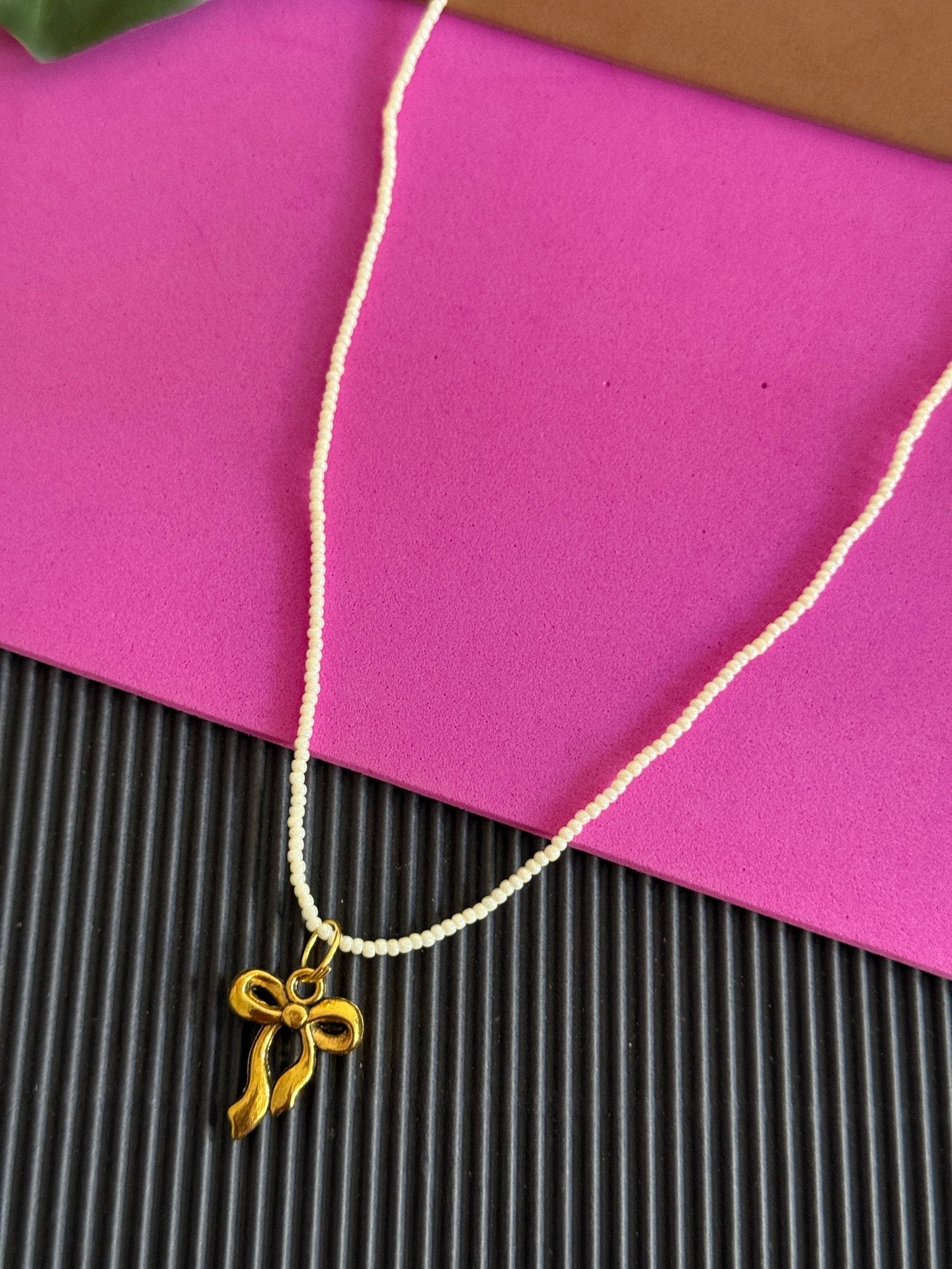 Beaded golden bow charm necklace - Kalakari