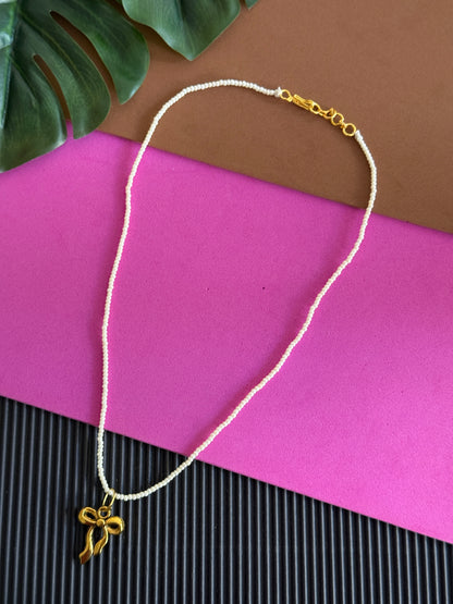 Beaded golden bow charm necklace