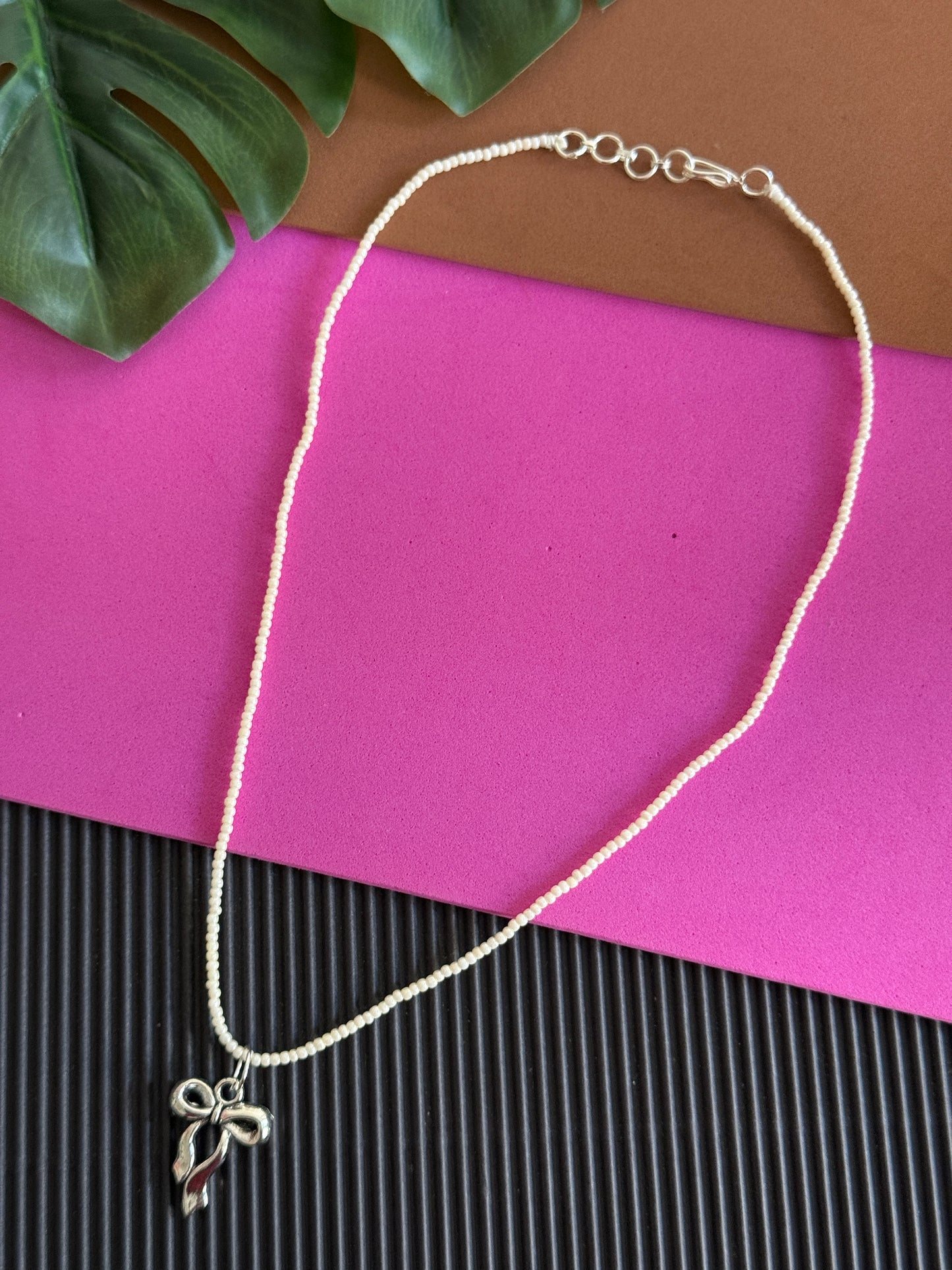 Beaded silver bow charm necklace